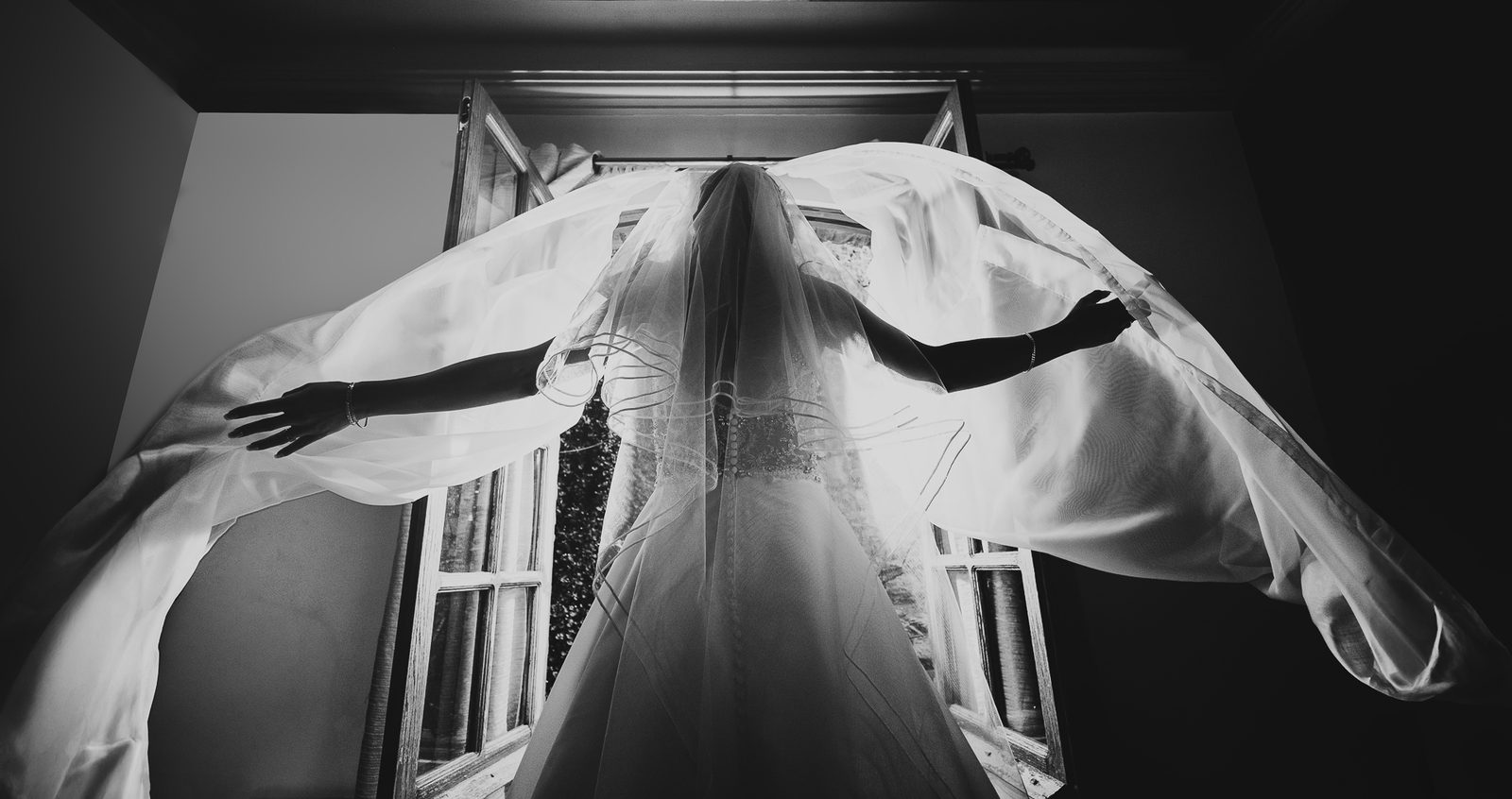Fotografía editorial en blanco y negro de novia con velo a contraluz, estilo característico del estudio Salicatus
